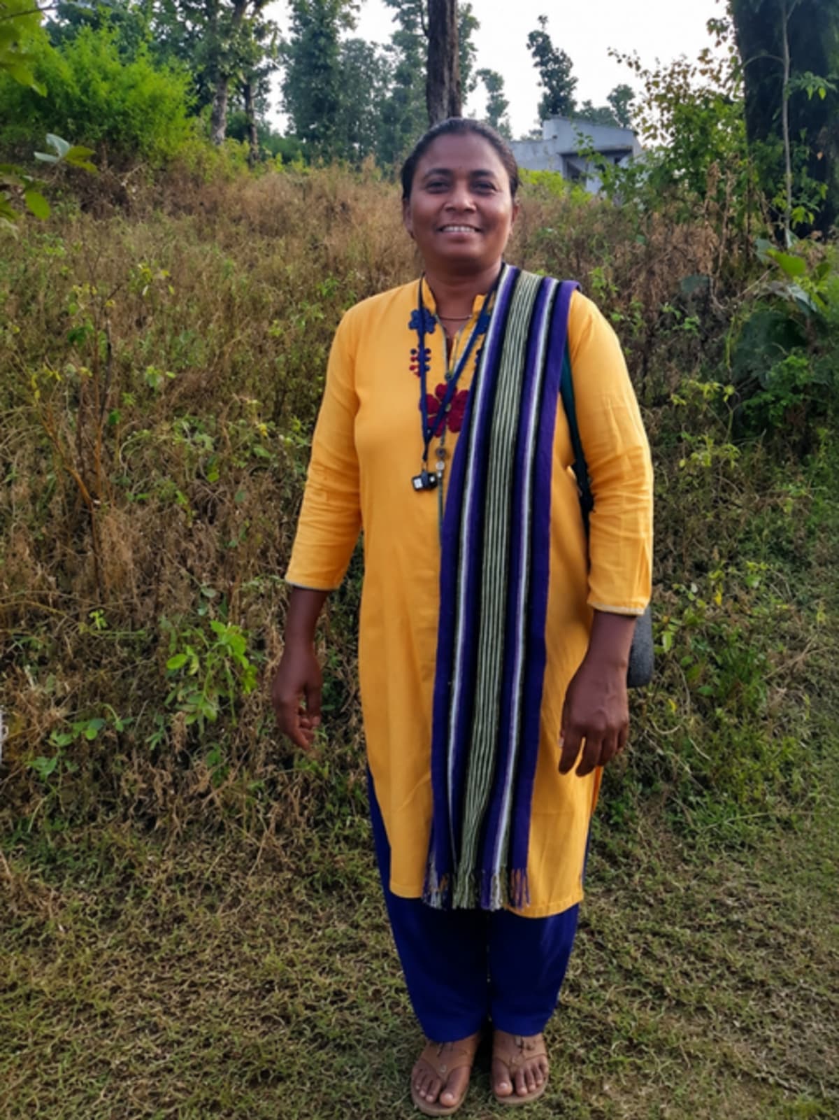 Neeta Patel standing with tribal women near check dam in Gujarat village