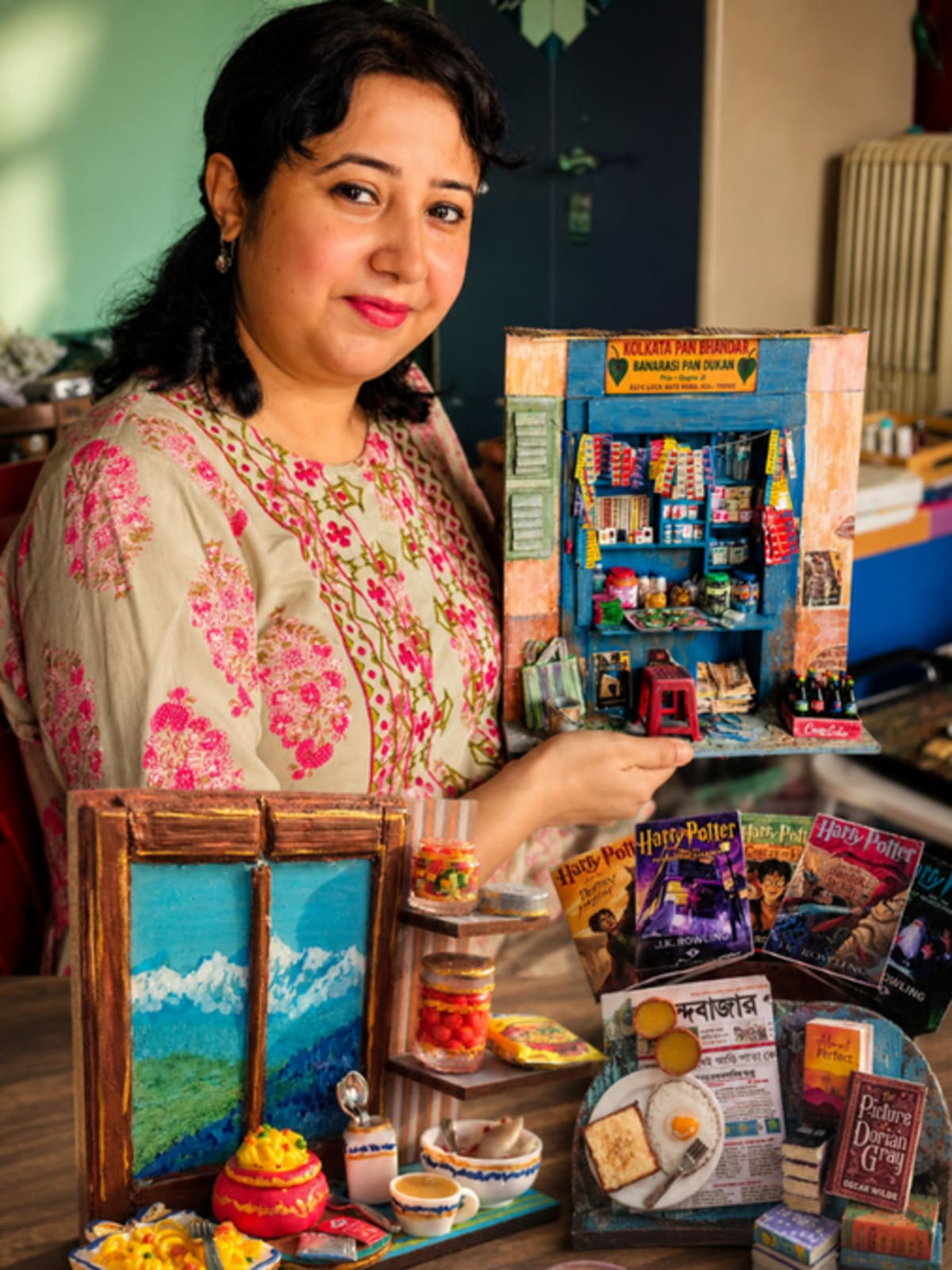 Detailed miniature clay replicas of Bengali cultural items including tram tickets and chai stalls