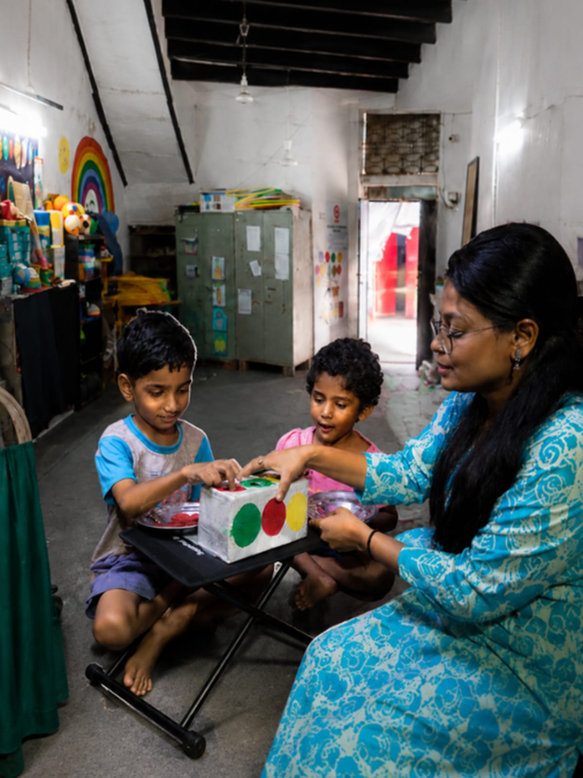 Colorful rainbow painted on wall by disabled children in Delhi community center