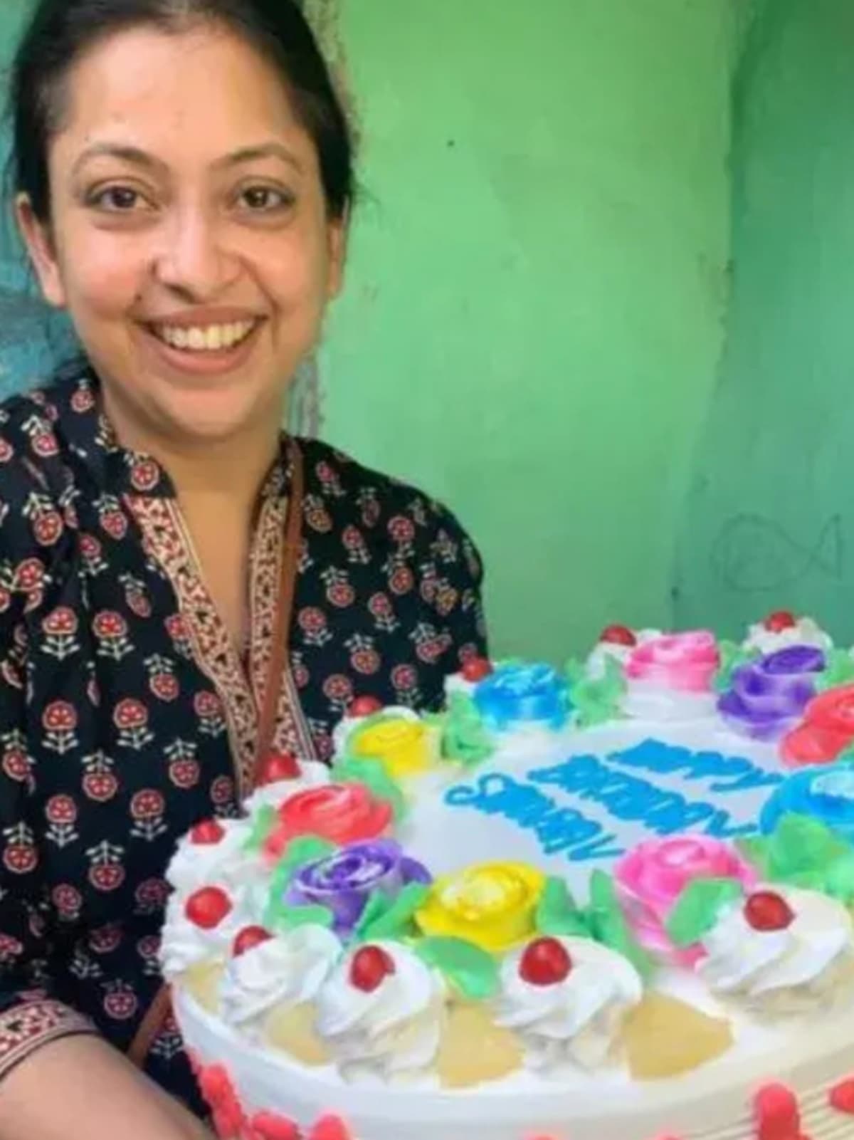 Children in Delhi slum celebrating birthday with cake provided by Payal Kumar's organization