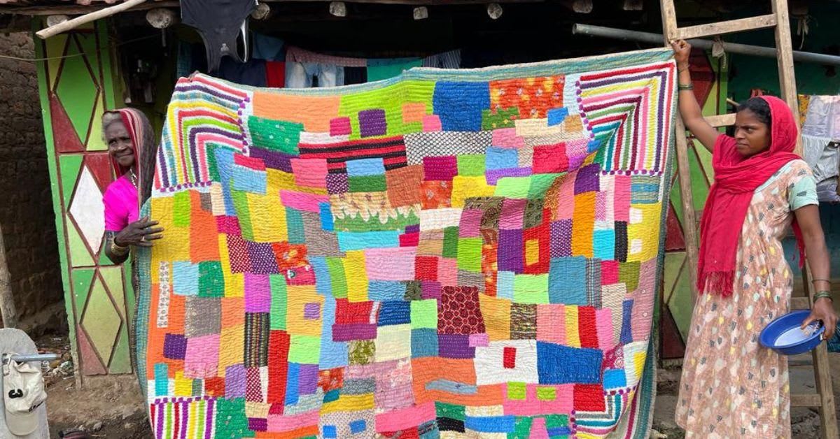 Siddi women in Karnataka village collaborating on colorful traditional kawandi quilt with intricate patterns