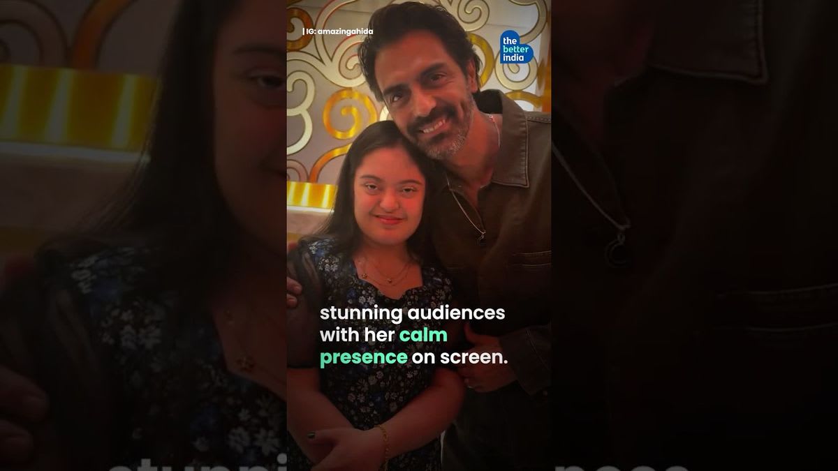 Ahida Sarmai smiling while performing on stage in traditional Indian attire