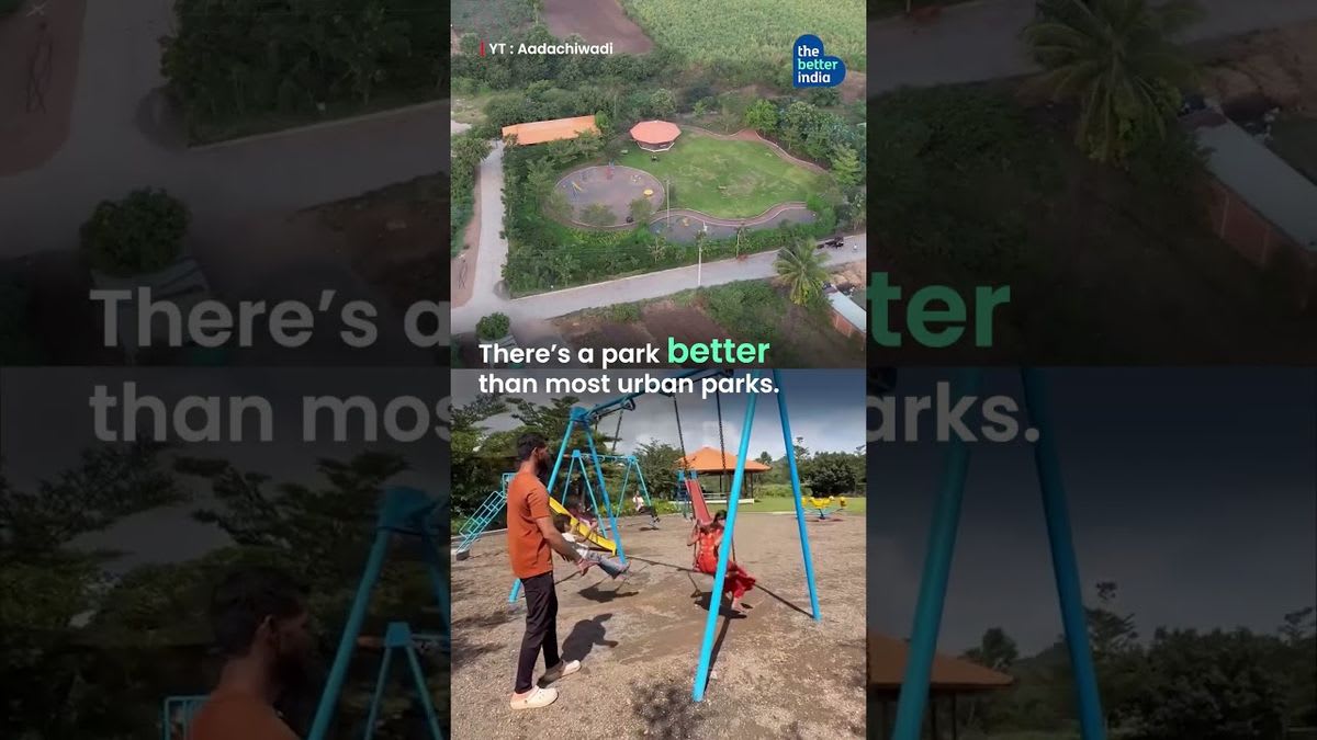 Solar panels on rooftops of rural Indian village with women farmers working in green fields