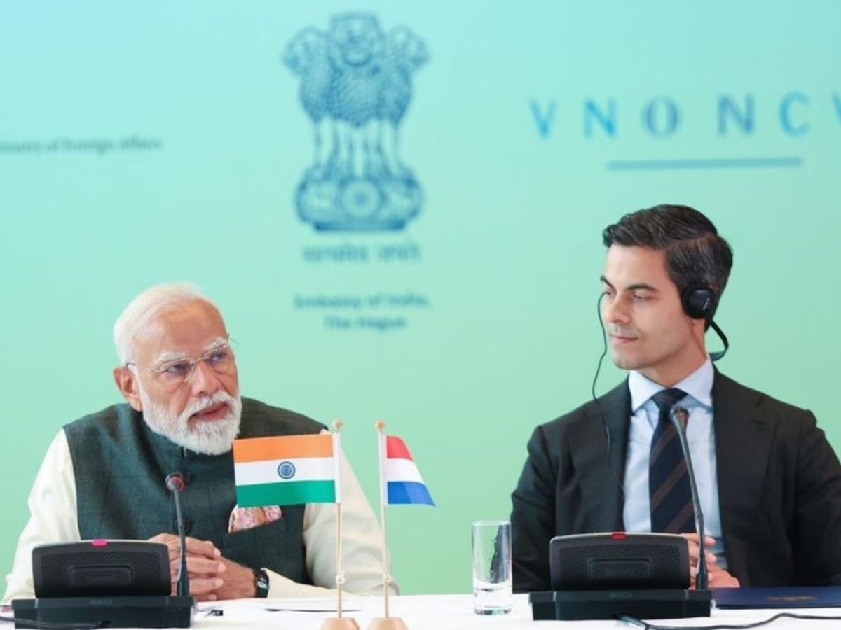 Indian and Dutch flags side by side with solar panels and semiconductor chips representing technology partnership