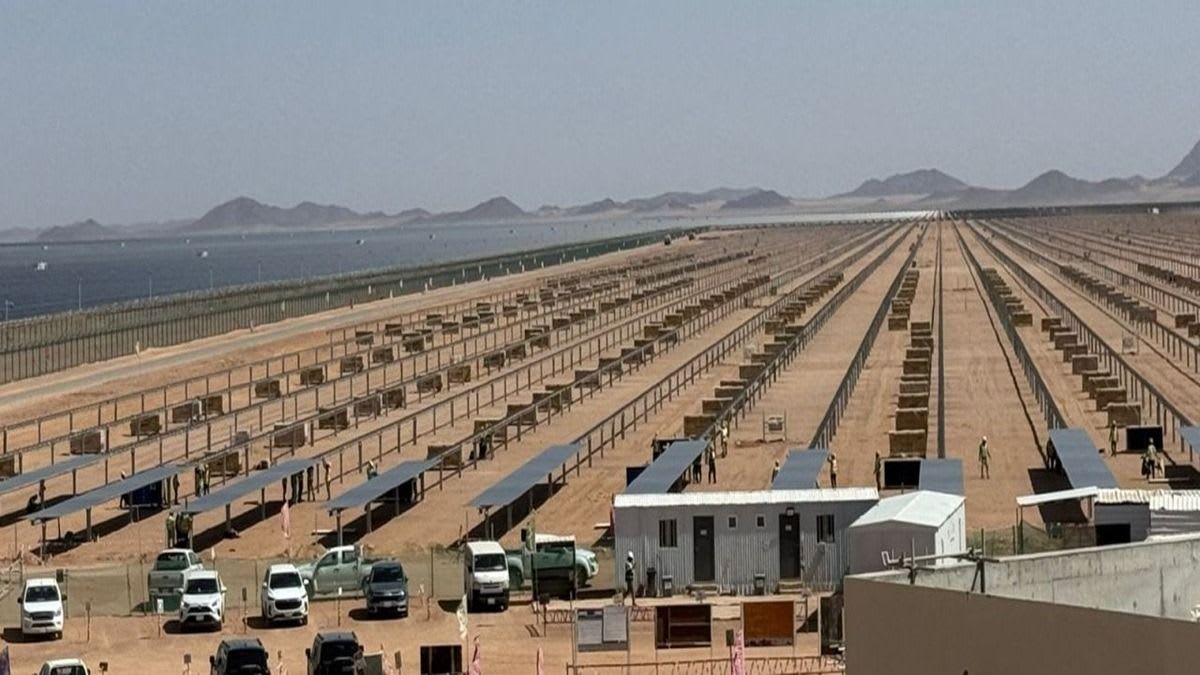 Solar photovoltaic panels being installed at Al Henakiyah 2 solar farm in Saudi Arabia desert