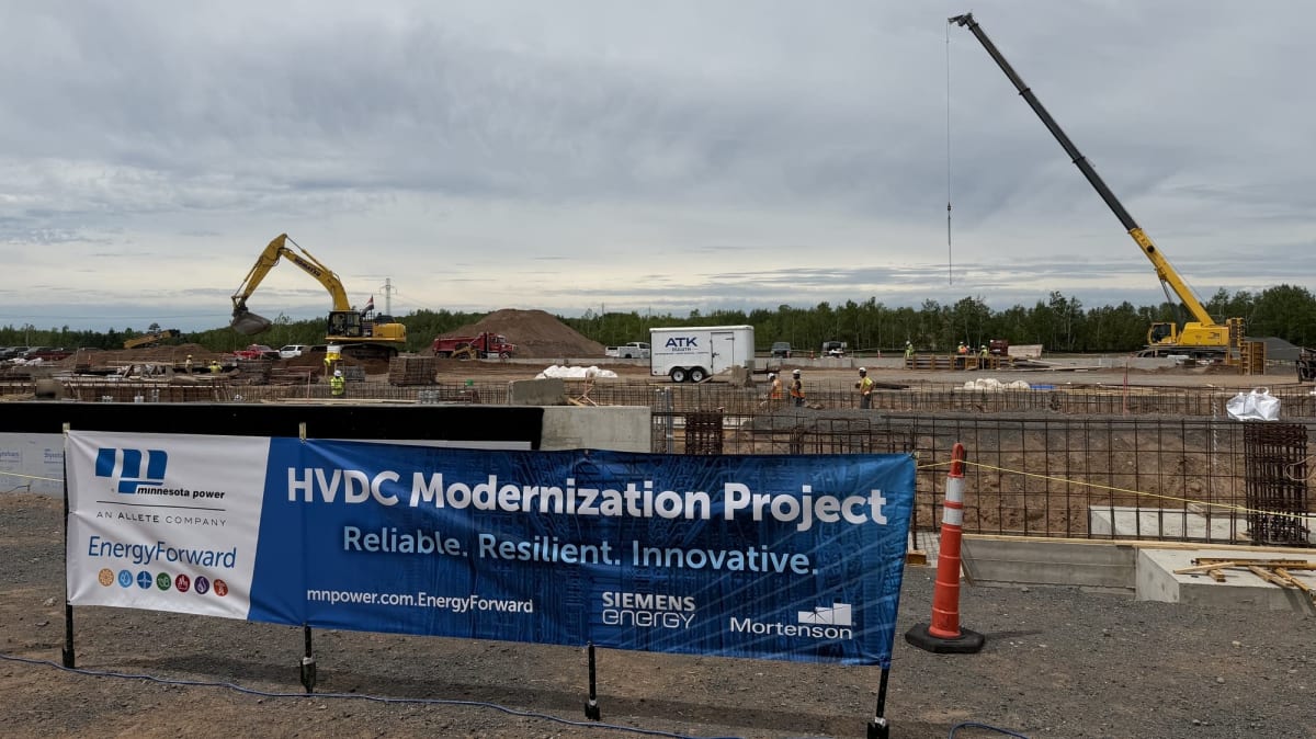 ** Construction site for new electric converter station in rural Minnesota surrounded by transmission towers
