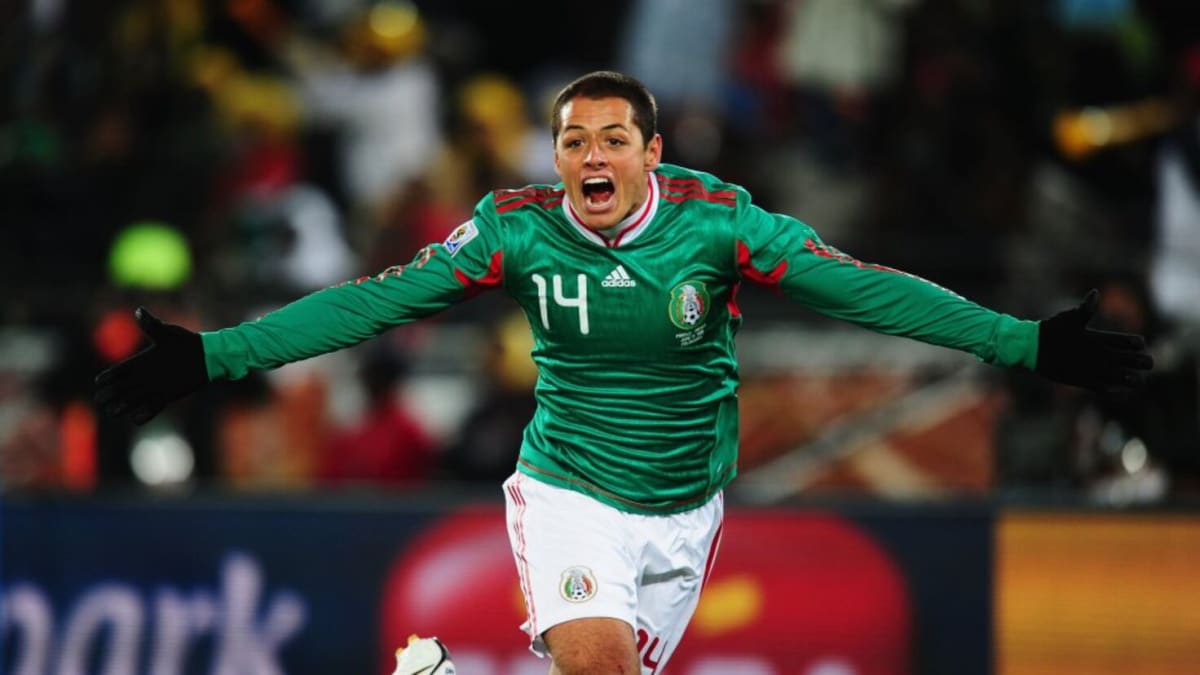 Mexican national soccer team players celebrating during a World Cup match in green jerseys