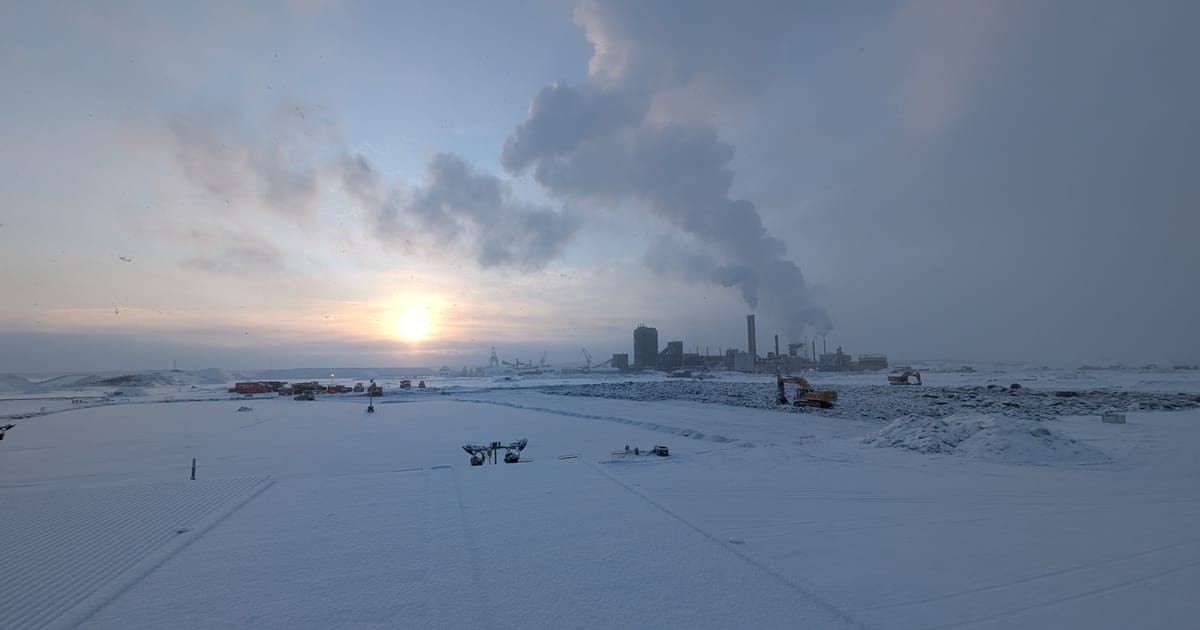 Modern steel production facility in northern Sweden near Arctic Circle with renewable energy infrastructure