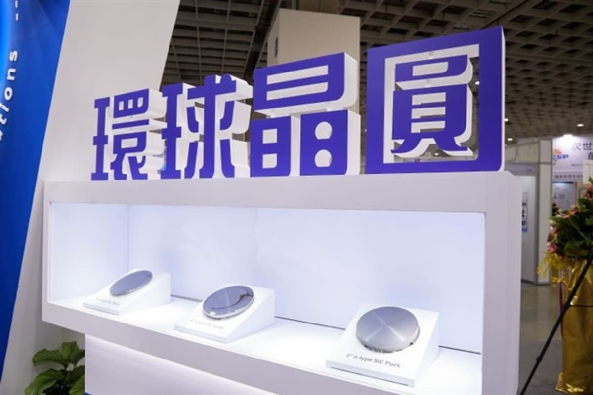 ** Semiconductor silicon wafers stacked together representing clean technology manufacturing and climate commitment