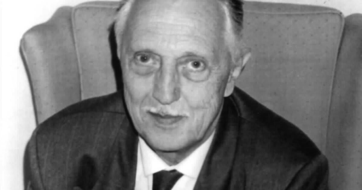 French geneticist Jérôme Lejeune working in laboratory conducting research on Down syndrome genetics