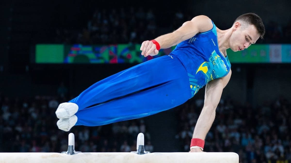 Kazakh gymnast Nariman Kurbanov performing pommel horse routine at Paris Olympics medal ceremony