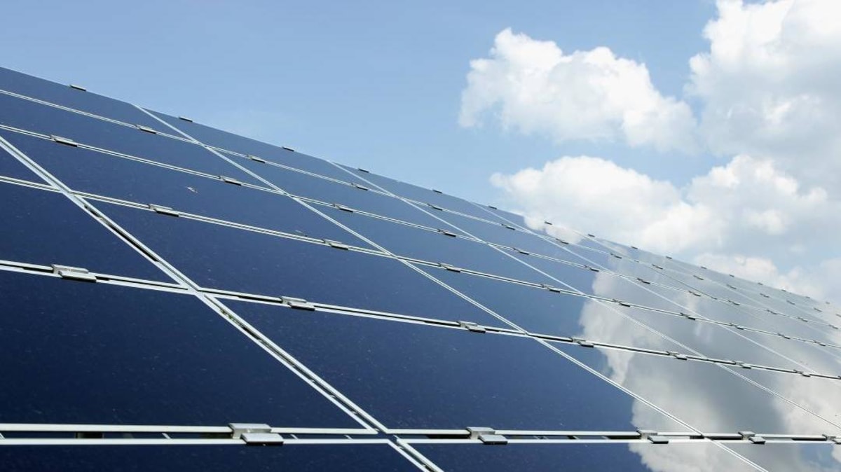 Rooftop solar panels installed on residential homes under bright sunny skies in Kerala