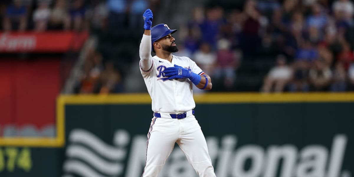 Texas Rangers players celebrating in dugout after scoring runs against Houston Astros