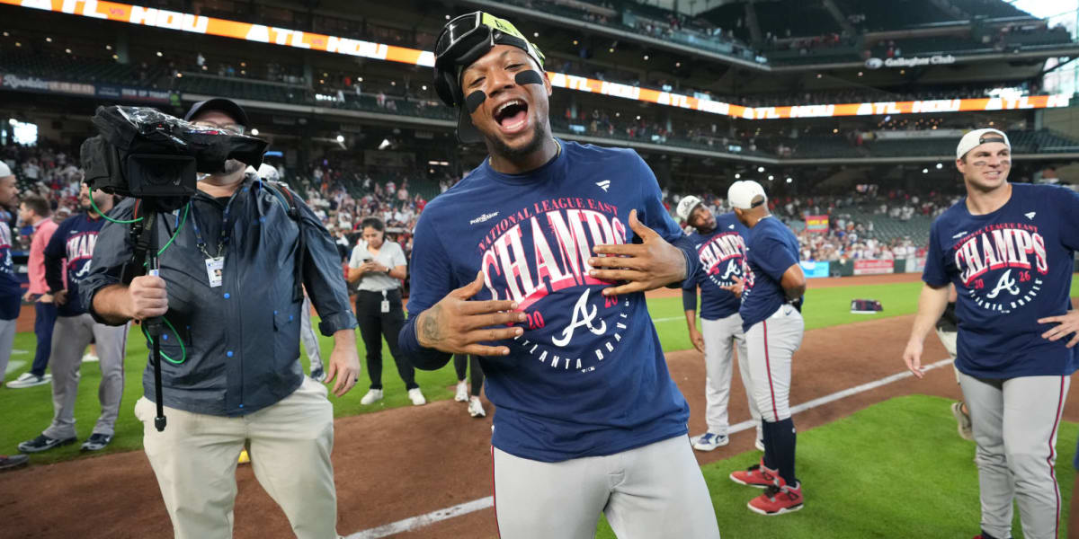 Atlanta Braves players celebrate on field after clinching National League East division championship