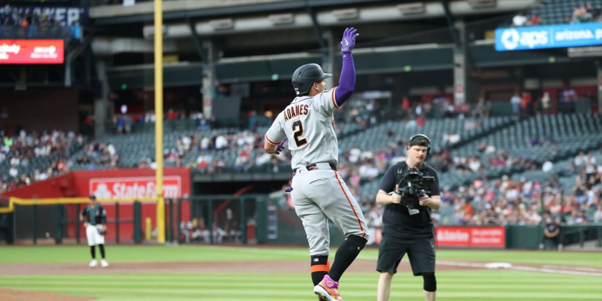 Baseball fan holds glove with home run ball after incredible two-night catching streak at Chase Field