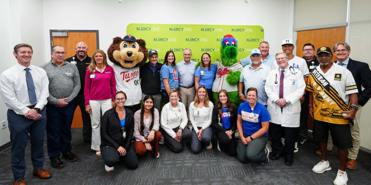 MLB Commissioner and Hall of Famers presenting large novelty tickets to smiling cancer patients