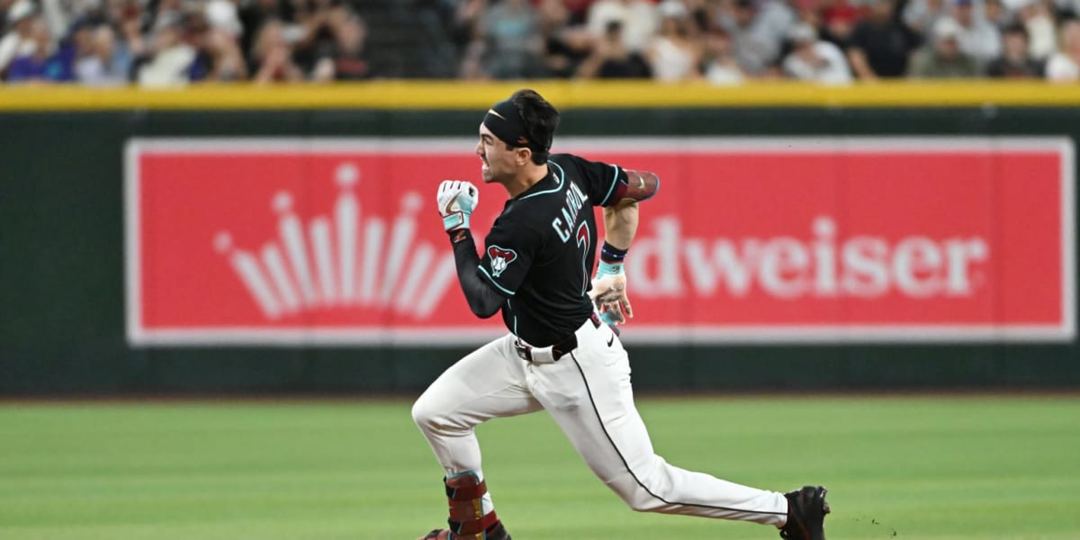 Corbin Carroll sliding into third base during Arizona Diamondbacks home game at Chase Field