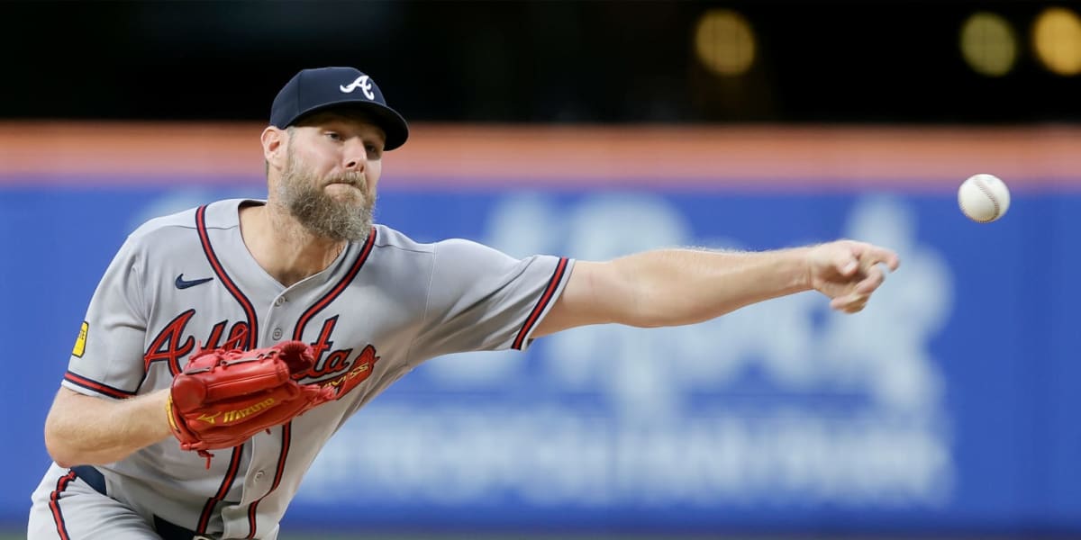 ** Chris Sale pitching for Atlanta Braves in white uniform, mid-delivery on the mound