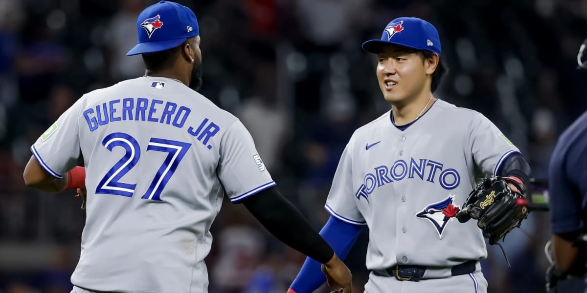 Kazuma Okamoto smiling in Toronto Blue Jays uniform at Rogers Centre baseball stadium