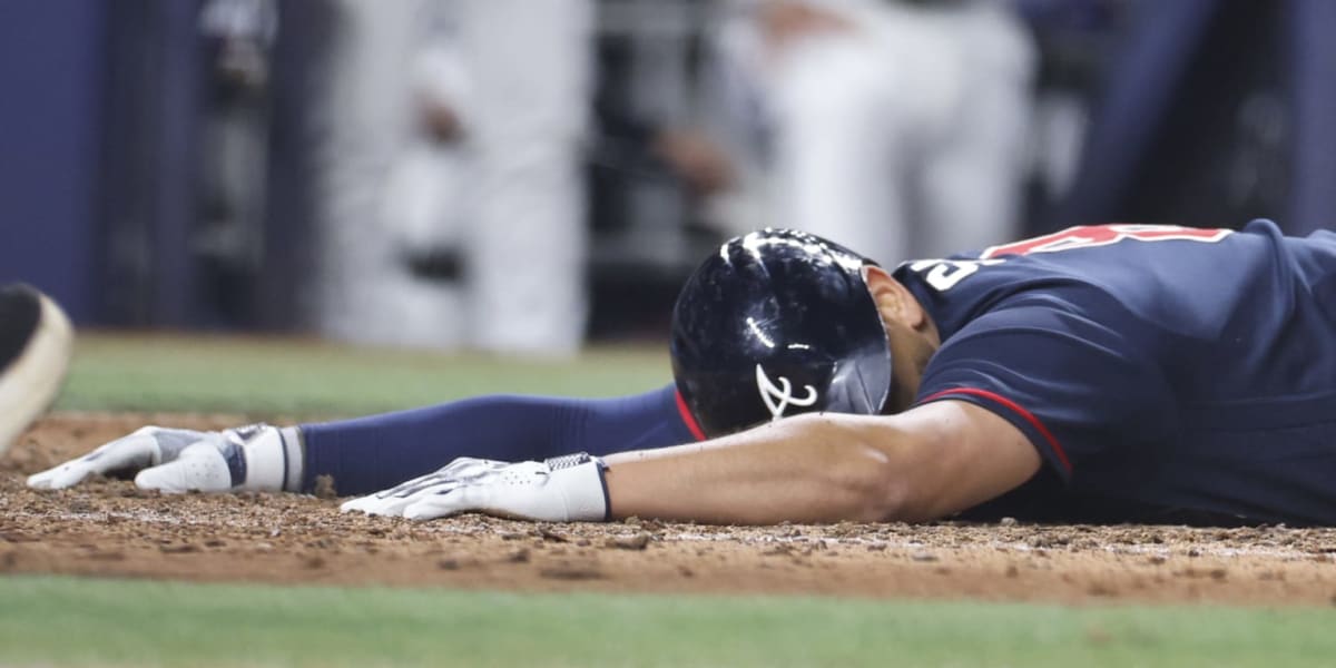 ** Dominic Smith sliding headfirst into home plate during Atlanta Braves game against Miami Marlins