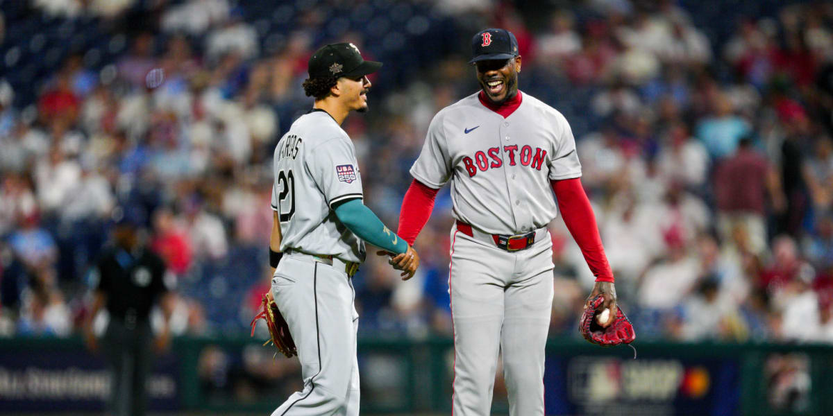 Seven Cuban baseball players in All-Star uniforms celebrating together on field in Philadelphia