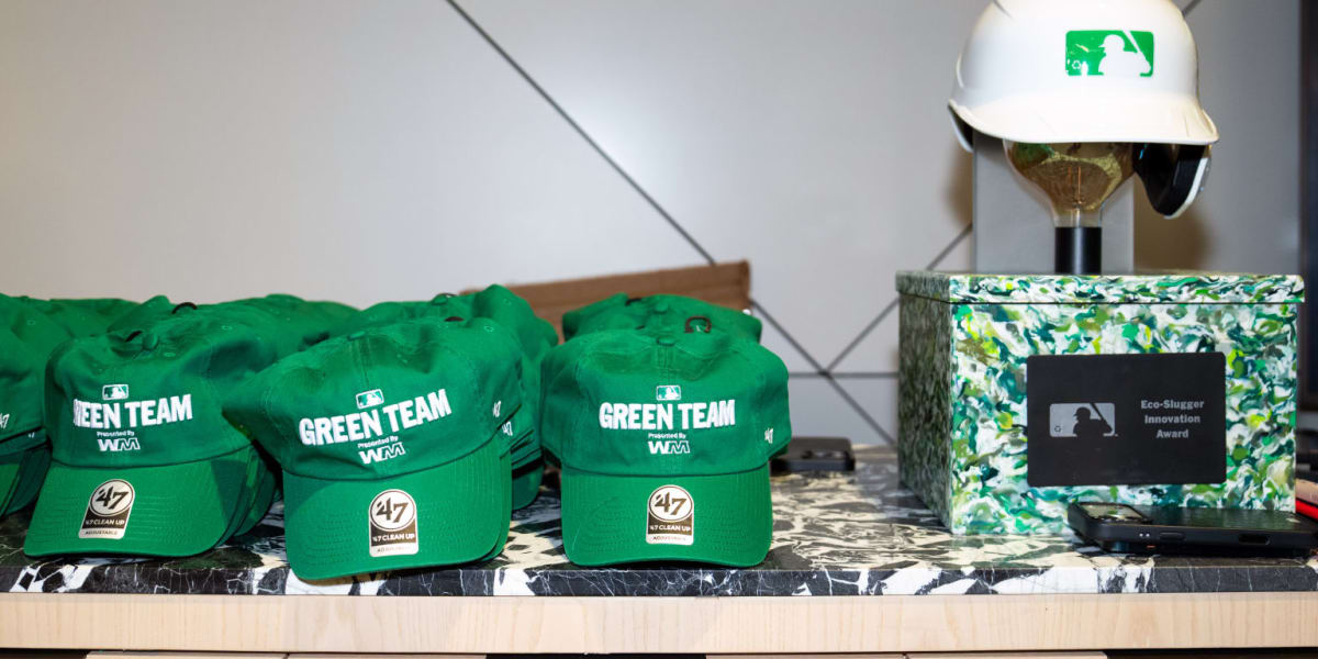 Baseball stadium with recycling bins and sustainable infrastructure during daytime game with crowd