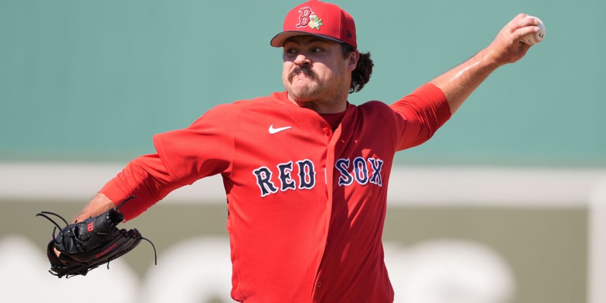 Young baseball pitcher Payton Tolle in Boston Red Sox uniform preparing to throw at Fenway Park