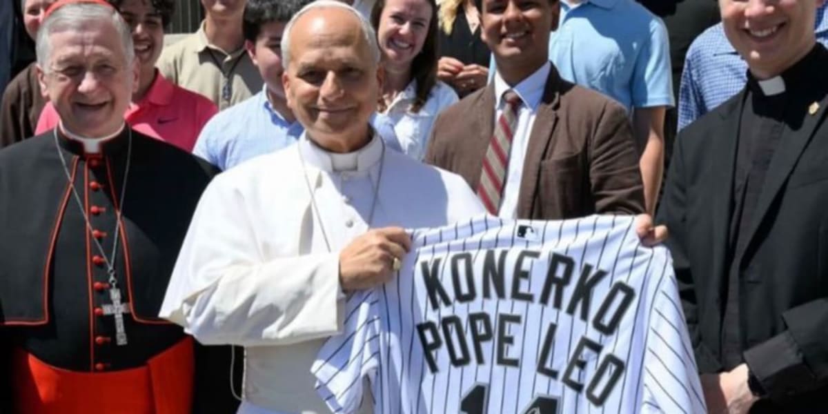 Pope Leo XIV smiling while holding signed Chicago White Sox jersey from Paul Konerko