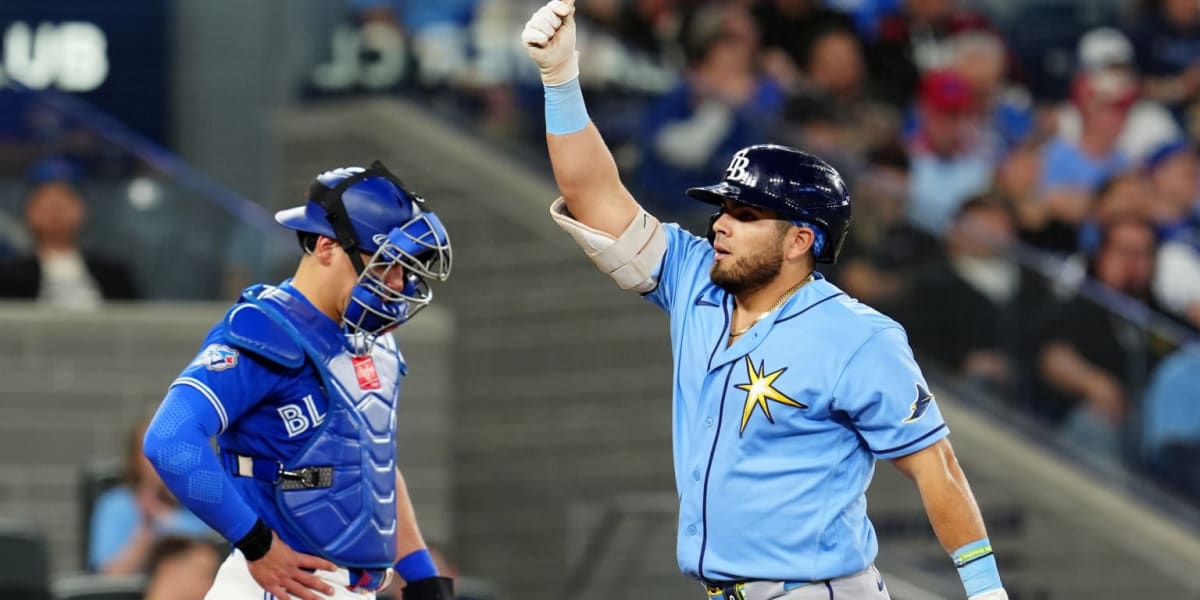Tampa Bay Rays baseball players celebrating together in dugout during winning game