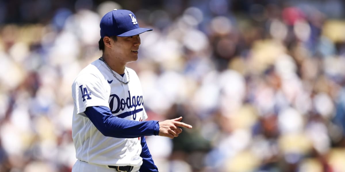 Yoshinobu Yamamoto pitching for the Los Angeles Dodgers in his white home uniform