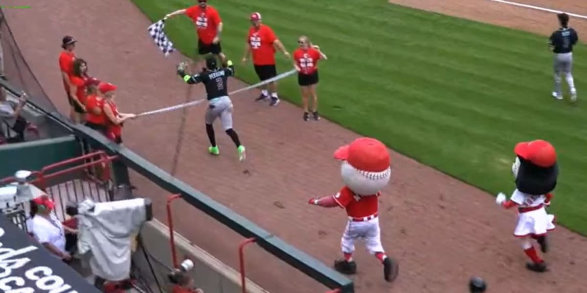Baseball player Geraldo Perdomo crossing mascot race finish line in front of costumed characters