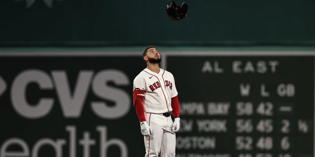 Boston Red Sox players celebrating together on field at Fenway Park during historic winning streak