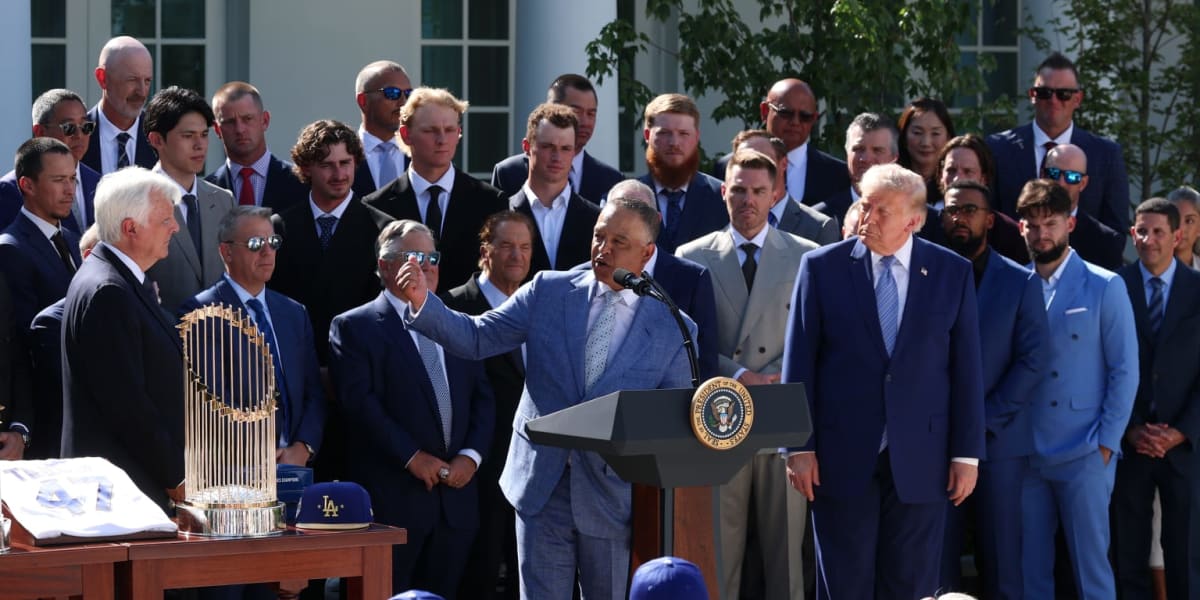 ** Los Angeles Dodgers players and coaches standing with two World Series trophies at White House
