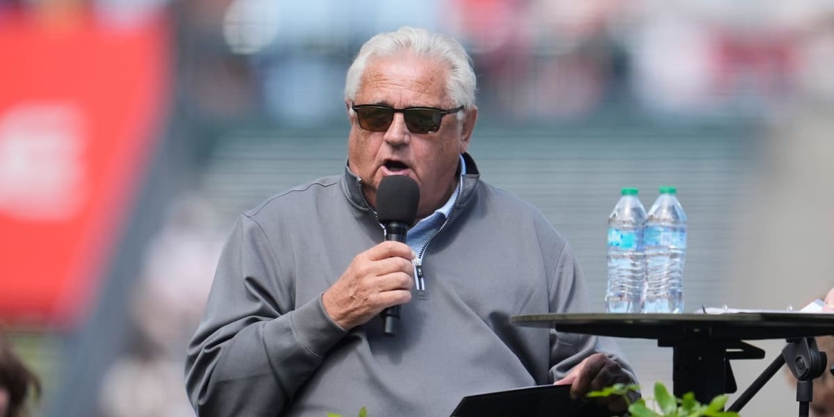 Giants broadcasters Duane Kuiper and Mike Krukow smiling together in the broadcast booth