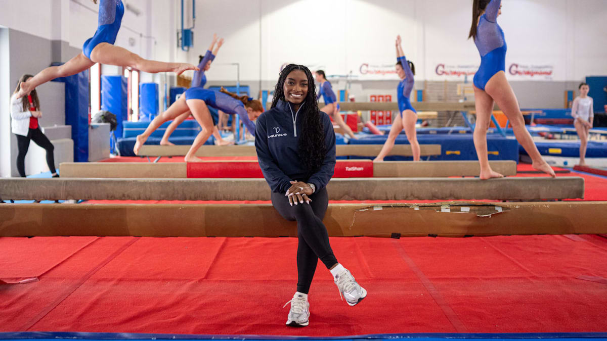Simone Biles smiling in athletic wear, seven-time Olympic gymnastics champion and mental health advocate