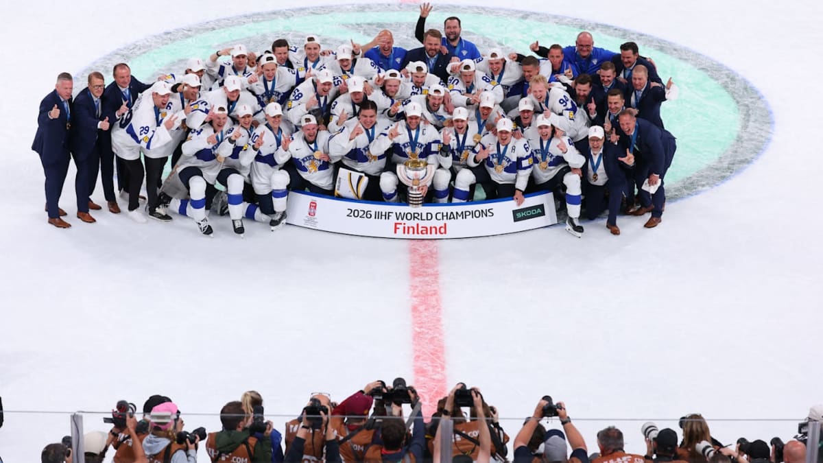 Finnish ice hockey players celebrating on ice after overtime championship victory in Zurich