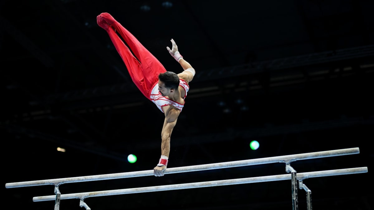 Turkish gymnast Ferhat Arıcan performing on parallel bars in competition