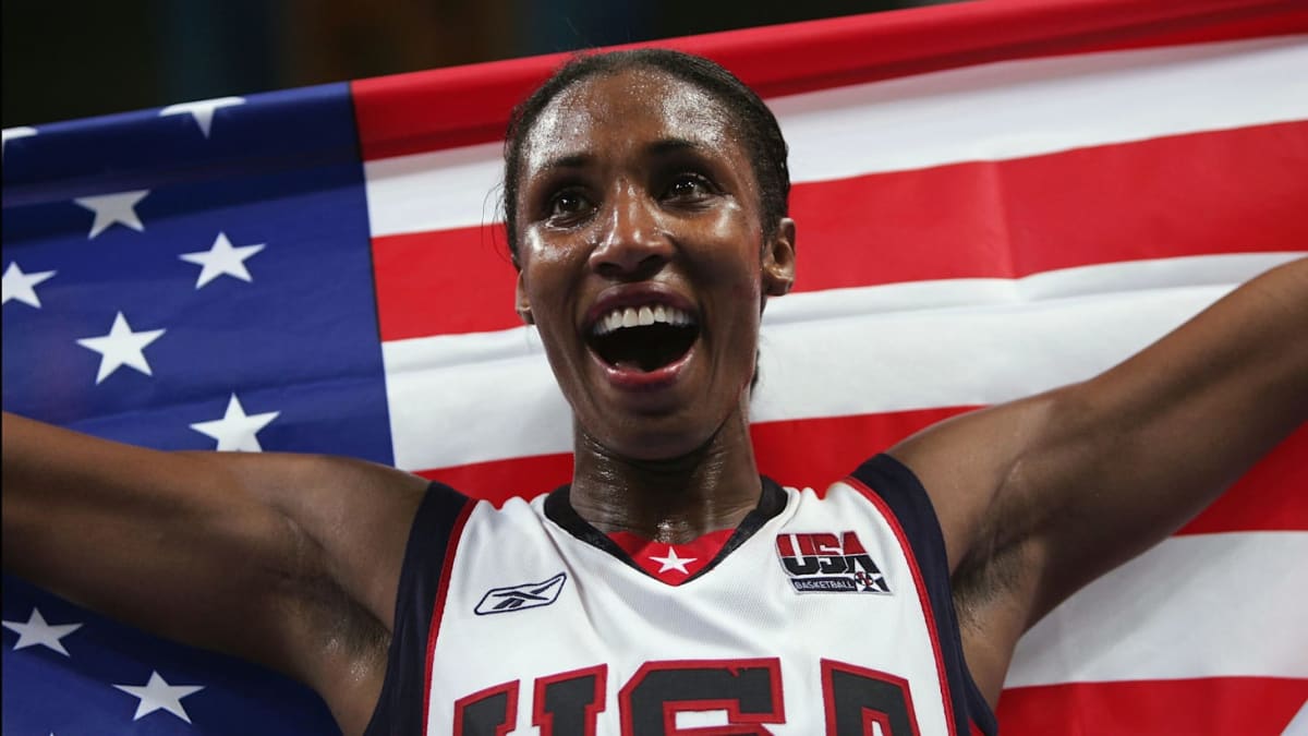 Lisa Leslie celebrates on Olympic podium wearing USA uniform with gold medal around neck