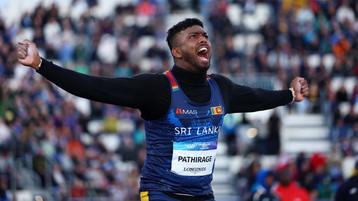 Rumesh Tharanga celebrating with Sri Lankan flag after winning Commonwealth Games javelin gold medal