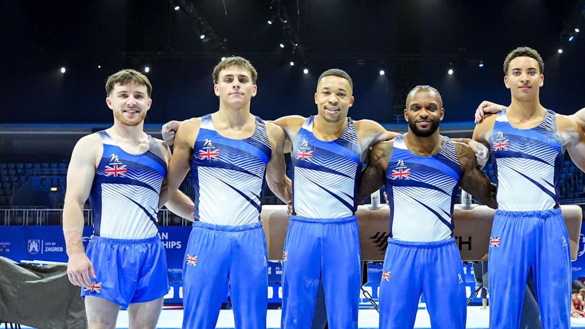 Five British gymnasts celebrating together on podium holding gold medals at European Championships