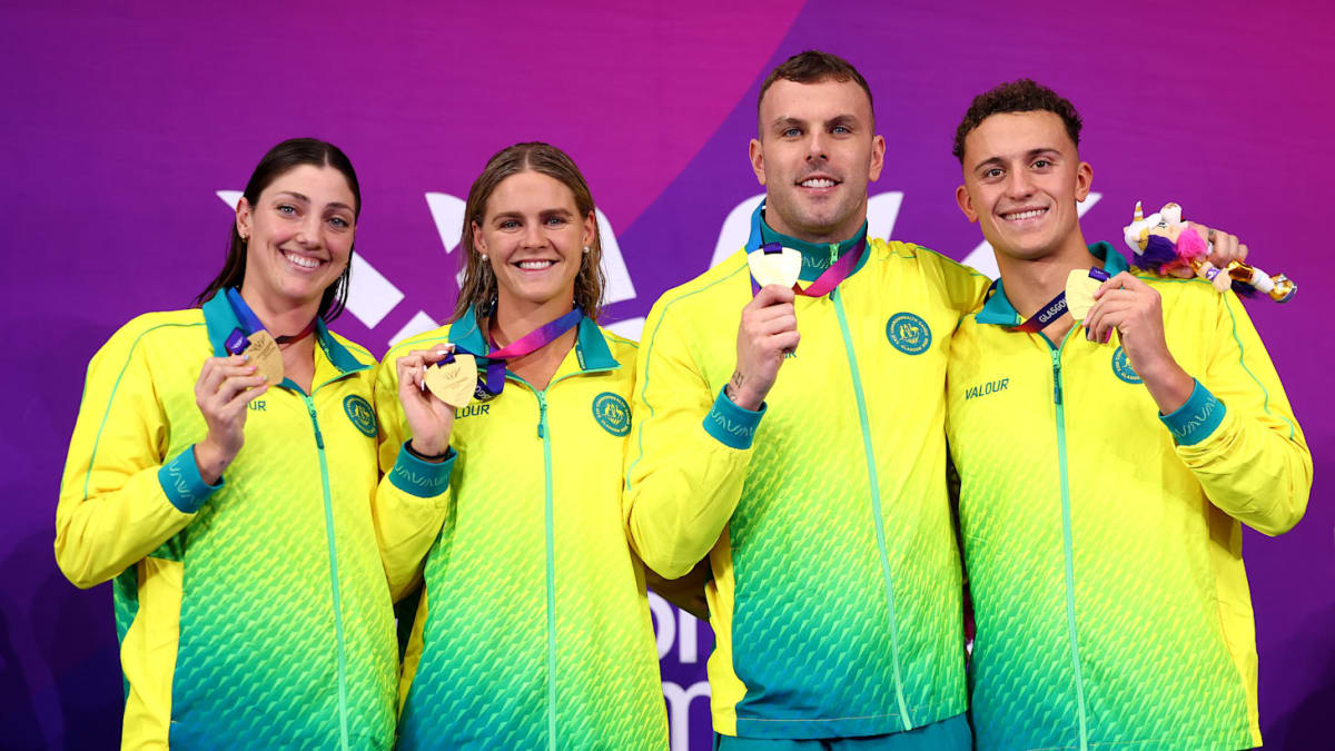 Four Australian swimmers celebrating together after winning gold medal at Commonwealth Games relay race