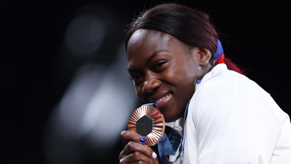 French judo champion Clarisse Agbégnénou competing in Olympic judo match wearing white gi