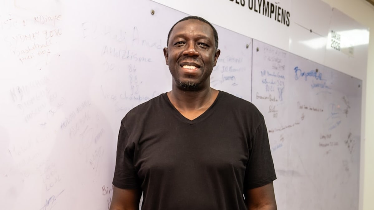 Olympic silver medalist Mous Sonko signing the Olympians' Wall in Dakar, Senegal