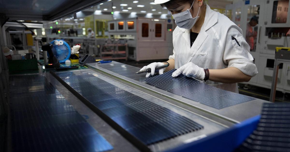 Solar panels being manufactured in a modern factory assembly line facility