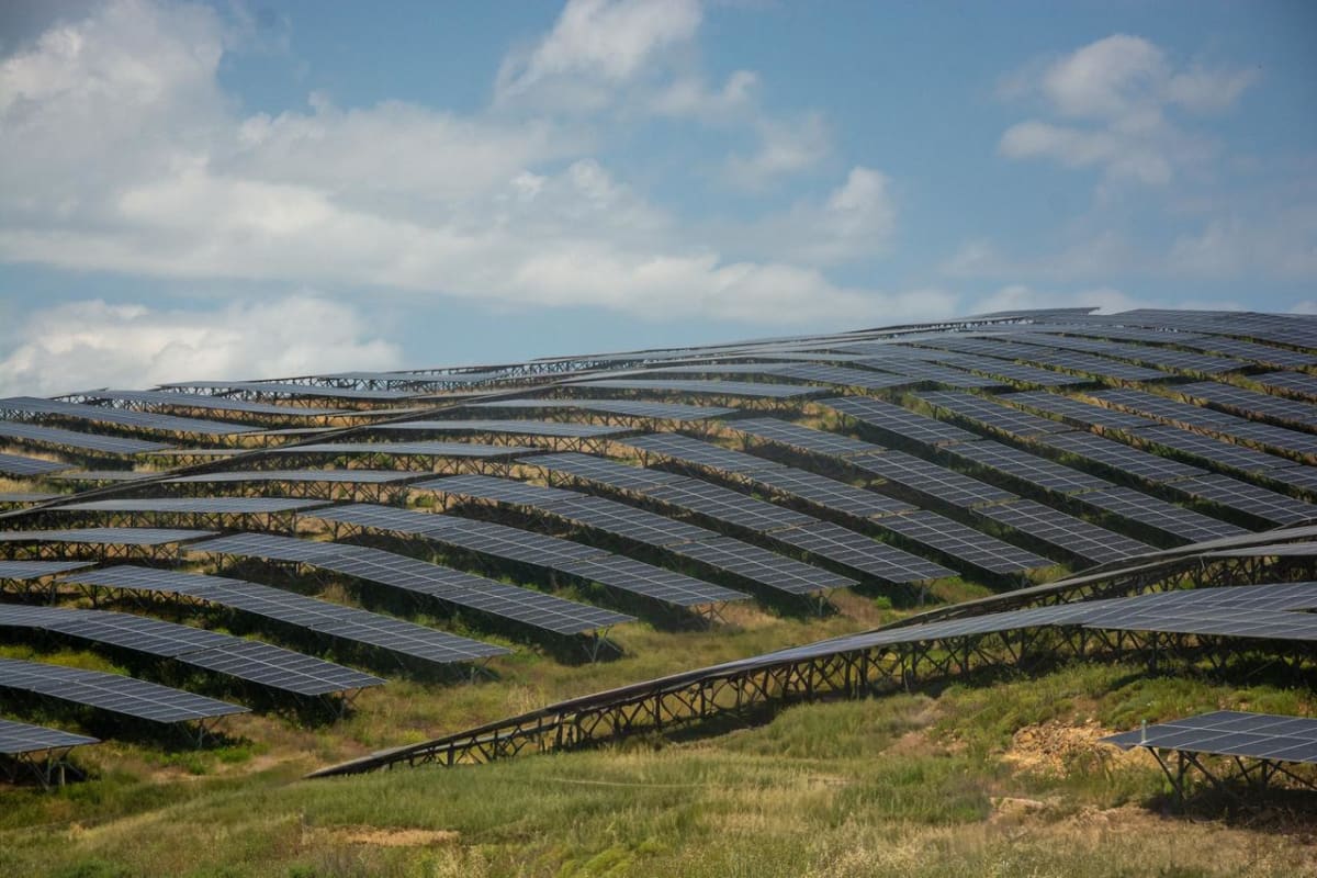 Rows of solar panels at renewable energy facility in Turkey under bright sunlight