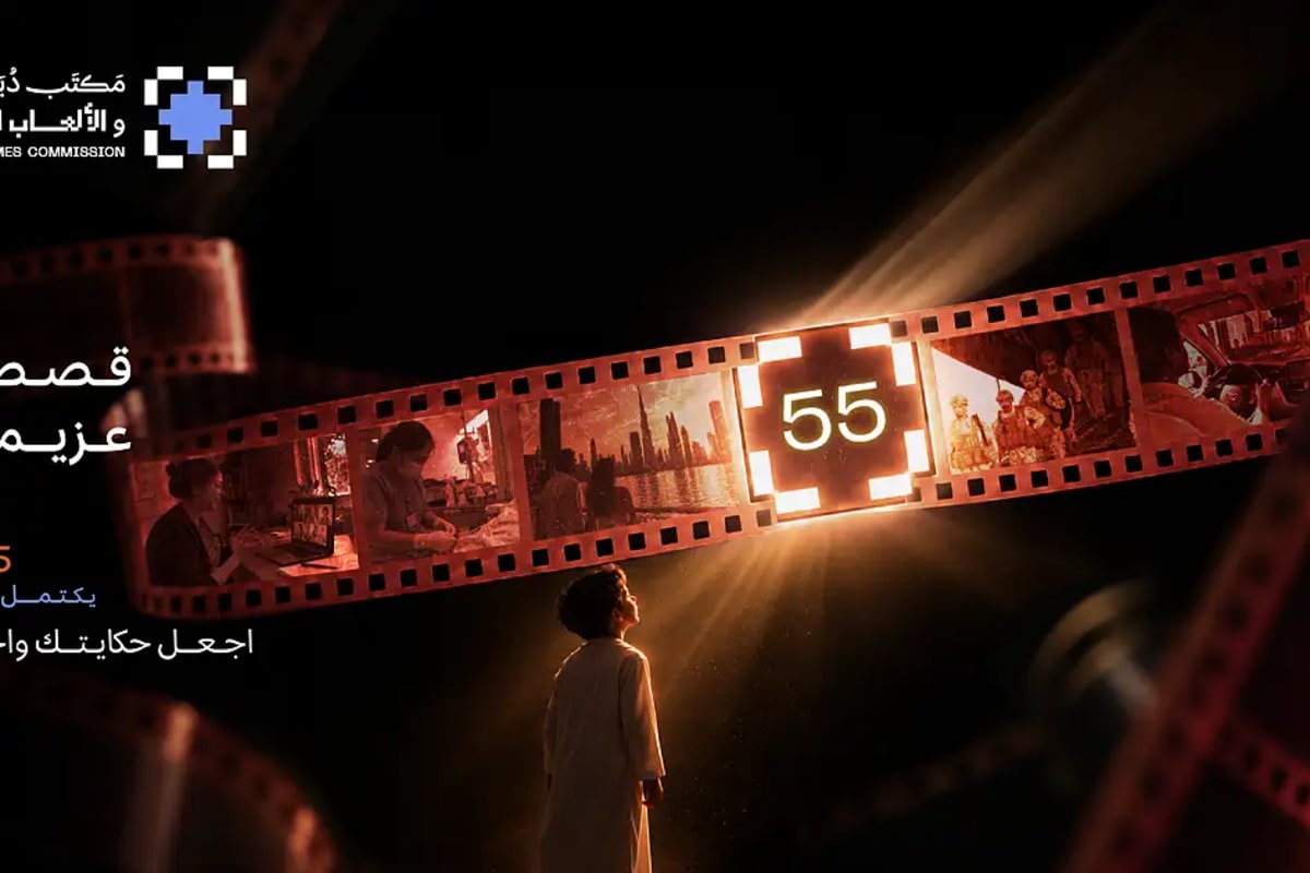 ** Filmmaker holding camera equipment with Dubai skyline in background during golden hour