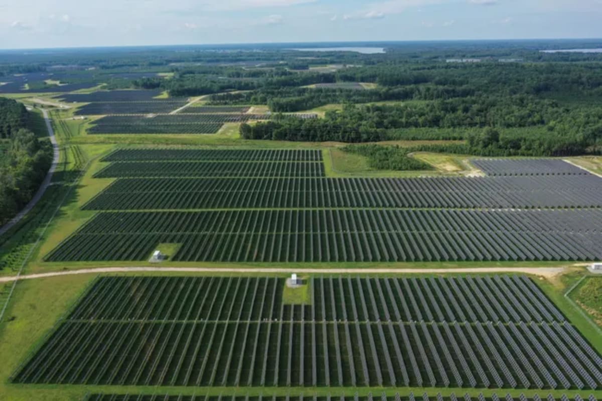 Solar farm with rows of photovoltaic panels under sunny sky in Georgia