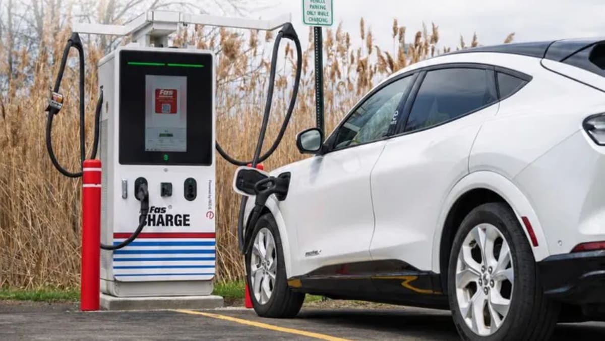 Electric vehicle charging at public station in apartment complex parking area