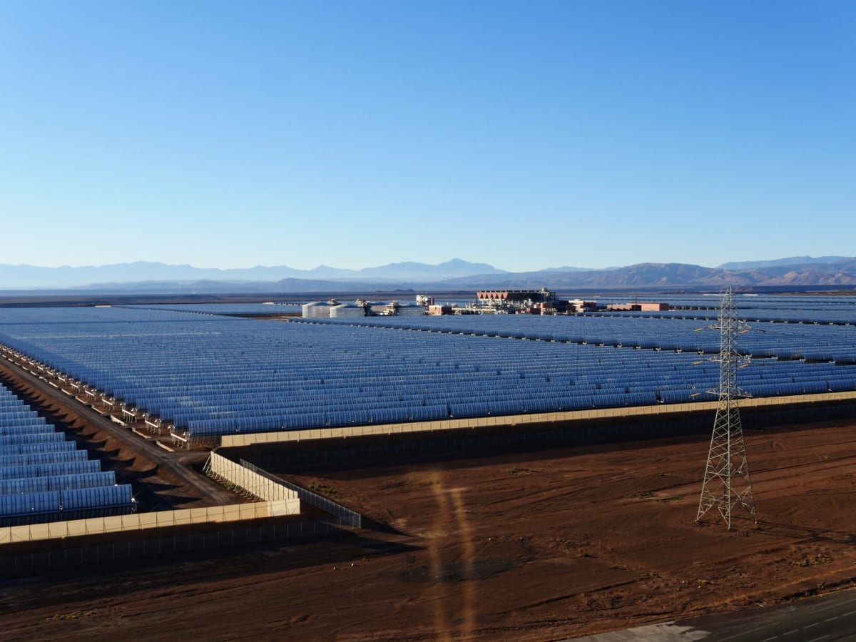 Solar panels at renewable energy facility in Africa under clear blue sky