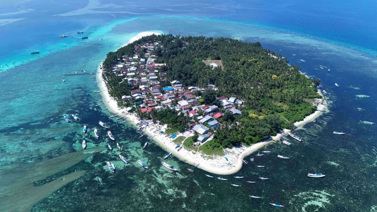 Aerial view of small tropical island surrounded by turquoise waters in South Sulawesi, Indonesia